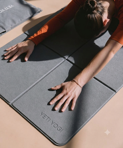 Woman using YETI YOGI foldable travel yoga mat